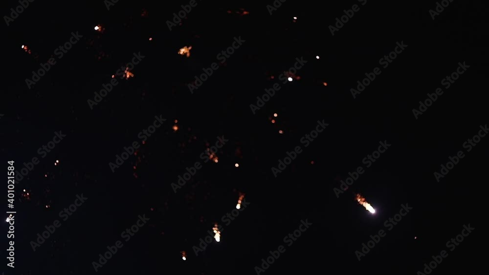 Fireworks with particles and sparks in the black night sky. Shining fireworks with bokeh. New year's eve firework celebration. Fireworks with particles and sparks in the black night sky. Shining fireworks with bokeh. New year's eve firework celebration.