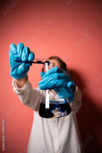 a young beautiful girl of European appearance conducts medical research. coronavirus vaccine concept