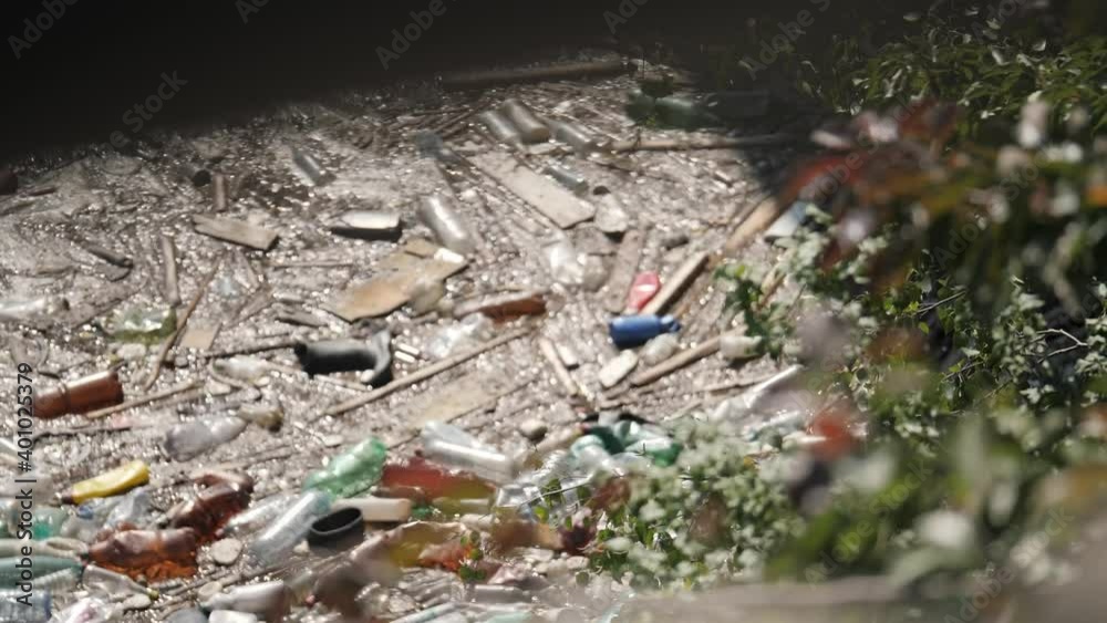 Floating Plastic bottles and different garbage in a polluted river water. Rubbish in a polluted water
