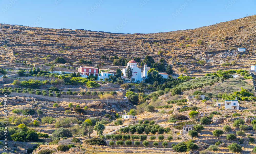 Panoramic view of dry desert landscapes in Syros, Cyclades, Greece with small orthodox church on the hill