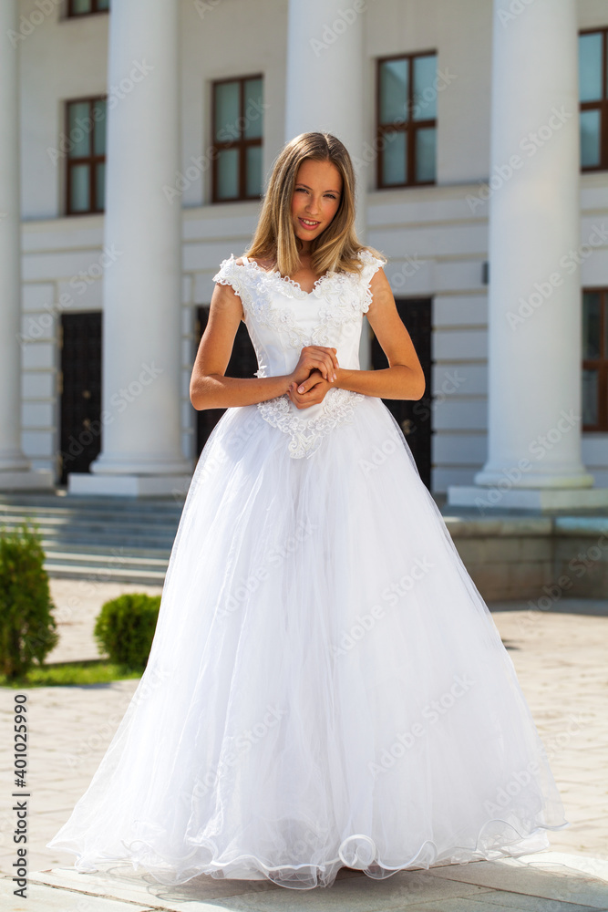 Young beautiful girl in ballroom prom dress