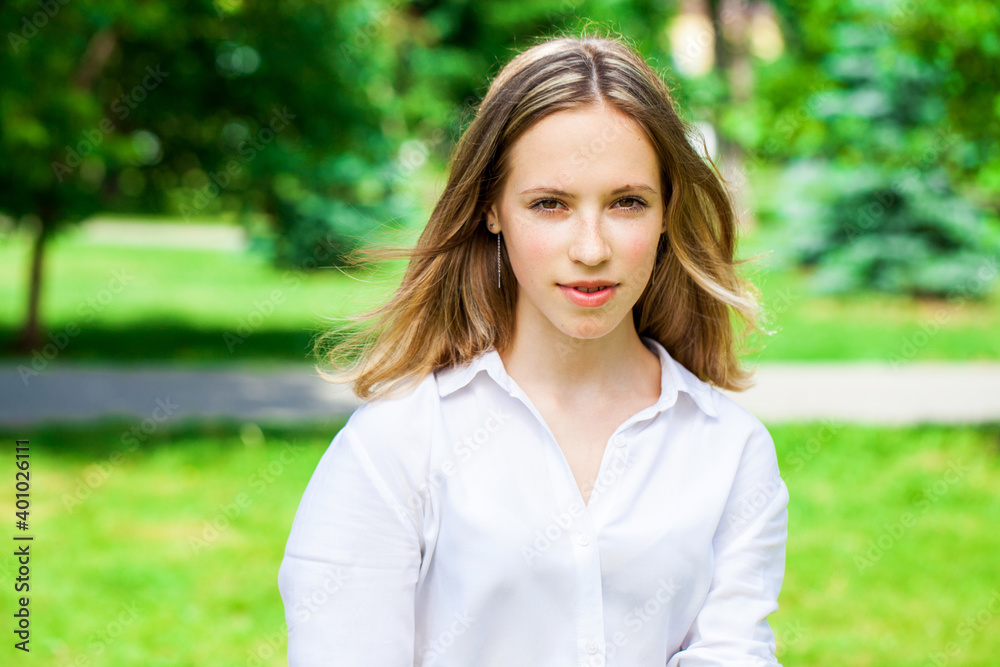 Portrait of a young beautiful brunette girl in summer park Portrait of a young beautiful brunette girl in summer park