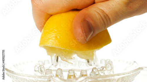 Squeeze lemon juice. Citrus juice. Hand squeezes lemon