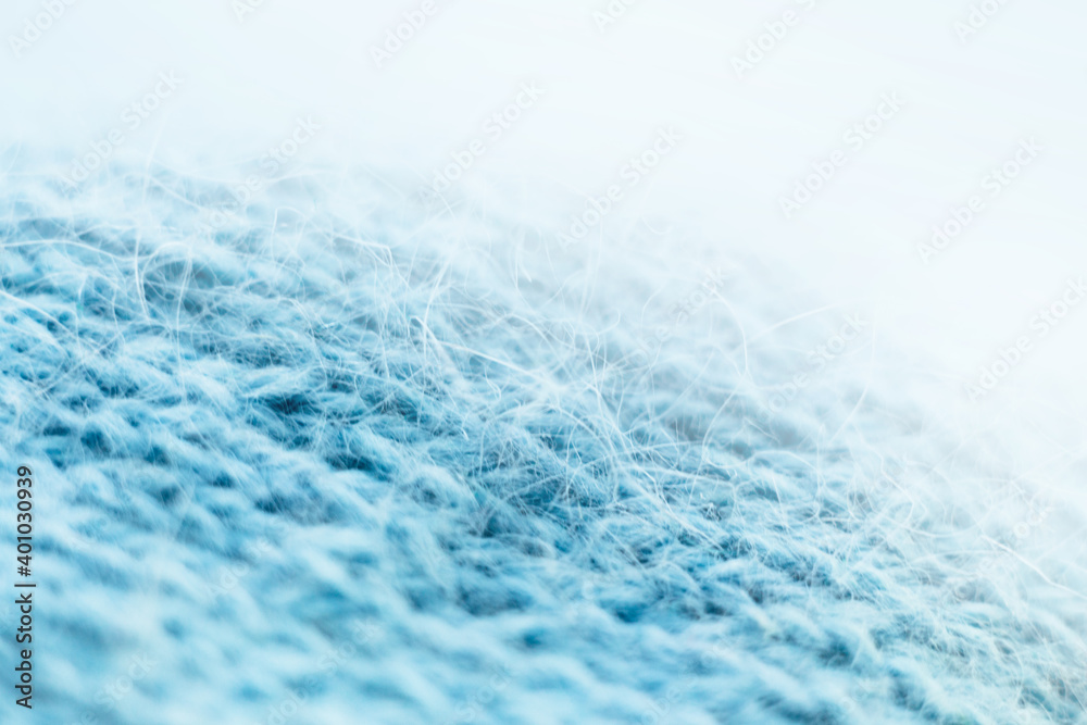 Obraz premium Knitted wool fabric texture background. Soft focus. Macro blur background. Blue woolen hand-knitted