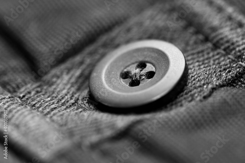 Monochrome image,button on new pants close up macro shot for background.