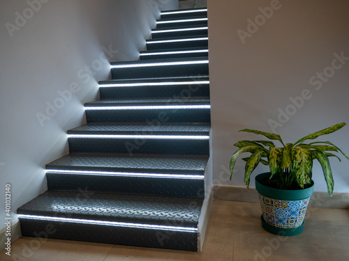 Stairs with lights on each step and floor next to it