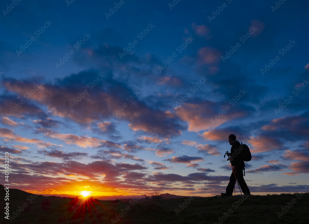 Mountaineer walking at sunrise in the Aiako Harriak Natural Park, Euskadi