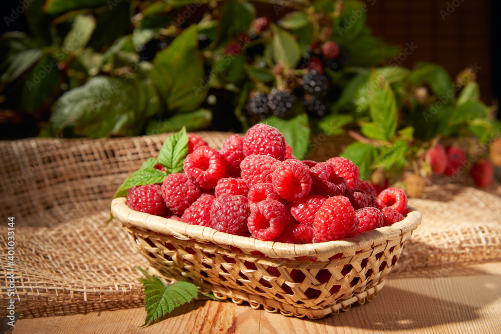 Blackberry with raspberries on a wooden background Blackberry with raspberries on a wooden background