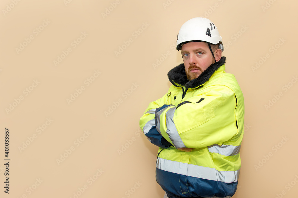 Male industrial worker in winter clothes. Bearded engineer with white hard hat helmet. Climber