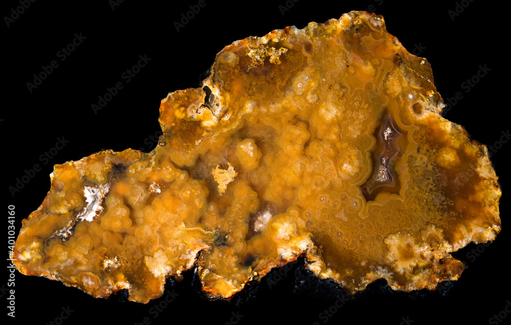 Sample of yellow agate from the Moscow region, half of a geode on a black background Sample of yellow agate from the Moscow region, half of a geode on a black background