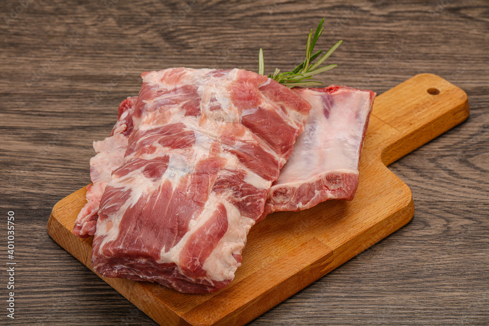 Raw pork ribs served rosemary