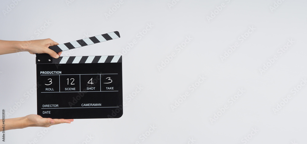 Hands is hold black Clapper board or Clapperboard or movie slate write in number. it use in video production ,film, cinema ,movie industry on white background.