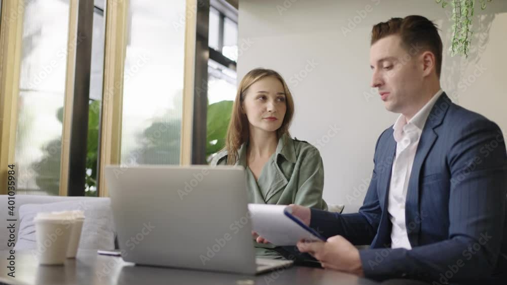 Meeting and discussion concept.business people communicating in office.Mature businessman discuss information with a colleague in a modern business lounge high up in an office tower. Meeting and discussion concept.business people communicating in office.Mature businessman discuss information with a colleague in a modern business lounge high up in an office tower.