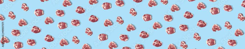 background with raw pork meat slices on blue background, raw food background, not pattern, banner wide shoot background with raw pork meat slices on blue background, raw food background, not pattern, banner wide shoot