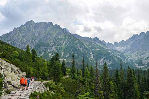 Group of tourist with backpacks walking on hiking trail in High Tatras mountains, Slovakia