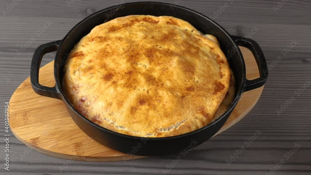 to put fresh baked yellow pie and cast-iron pan on table. concept of homemade cooking to put fresh baked yellow pie and cast-iron pan on table. concept of homemade cooking