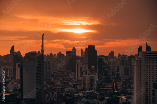 Sunrise over high-rise office building in business district at Bangkok