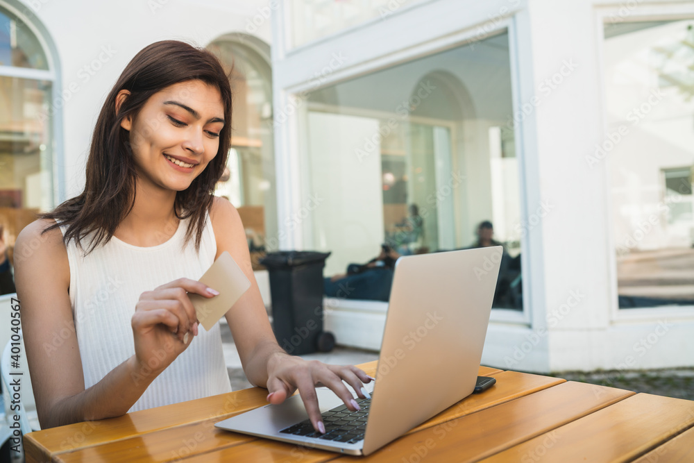 Young woman using laptop to shop online. Young woman using laptop to shop online.