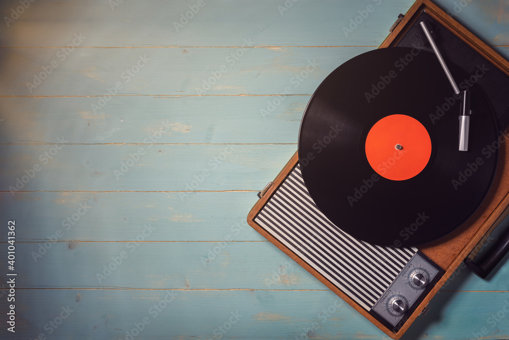 Old record player from the 70s with a vinyl record on green wooden table,  top view and copy space. Stock Photo | Adobe Stock