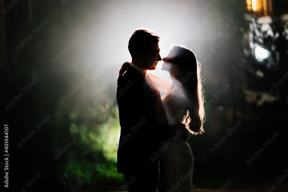silhouettes of a man and a woman in love in the dark. 