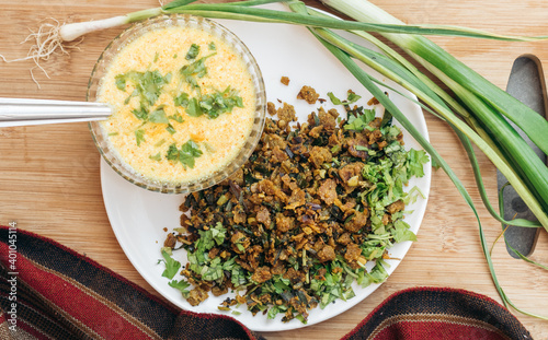 Top view of Indian food Kathiavadi dish - Vagarelo Rotlo with spicy curd on wooden board photo