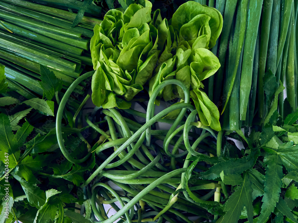 Fototapeta premium Background of fresh green vegetables and herbs. Top view.