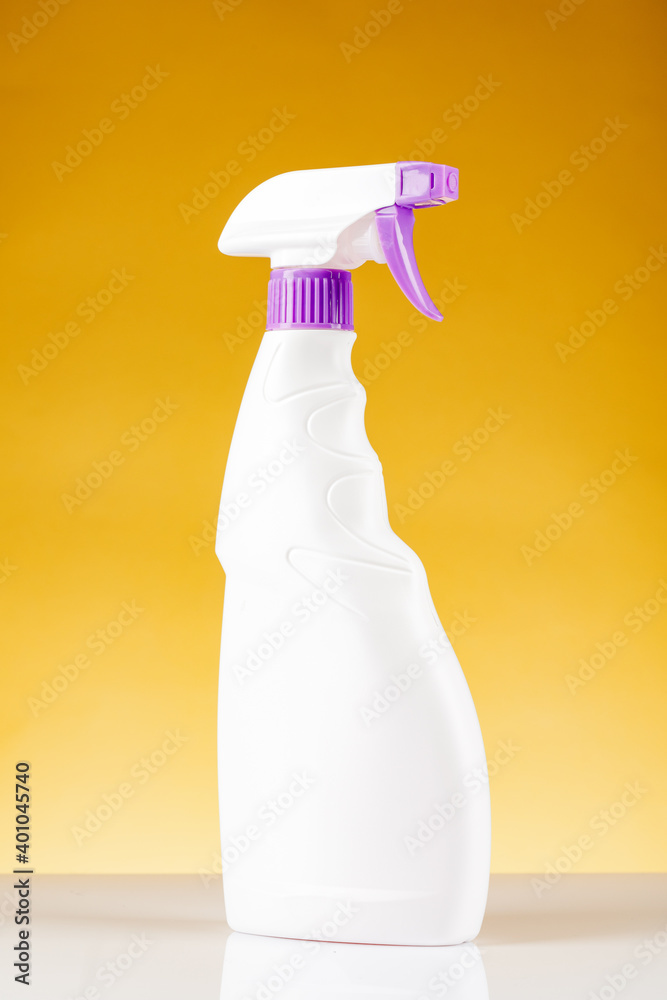 Plastic spray bottle. On yellow background Plastic spray bottle. On yellow background