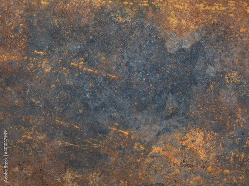 Rusty metal surface with streaks of rust. Rusty corrosion. Orange rust and dirt on steel enamel. Rusted grey and yellow abstract texture. Corroded gray metal background. Trendy colors pattern.