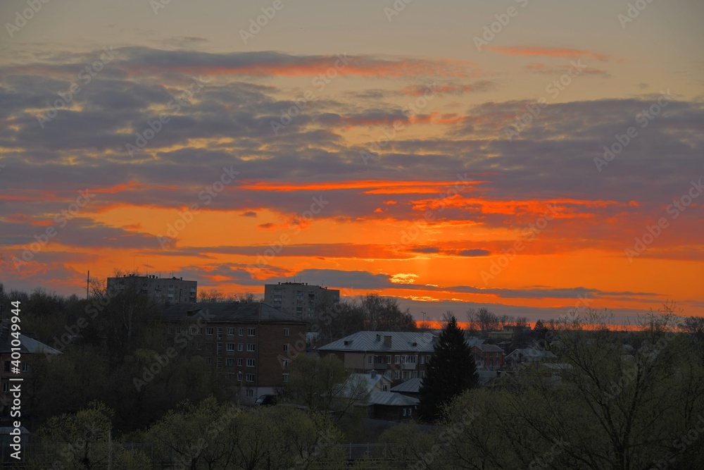 Sunrise with red clouds over the city