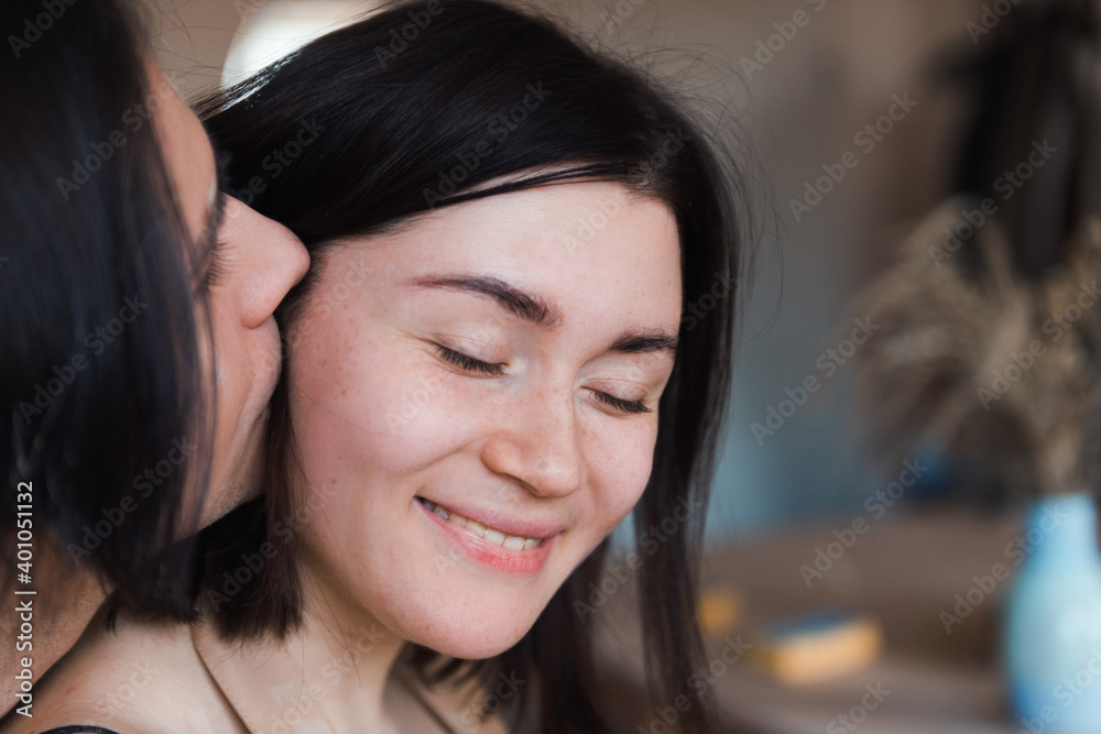 Loving couple man and woman kissing in pottery studio, dating in ceramics workshop Loving couple man and woman kissing in pottery studio, dating in ceramics workshop