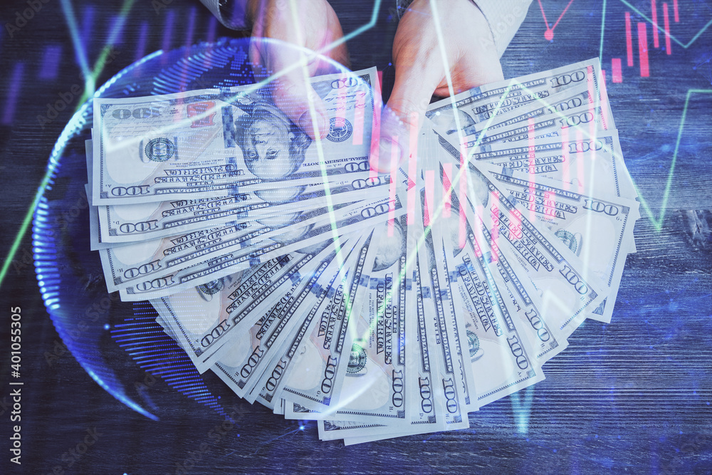 Multi exposure of financial graph drawing hologram and USA dollars bills and man hands. Analysis concept. Multi exposure of financial graph drawing hologram and USA dollars bills and man hands. Analysis concept.
