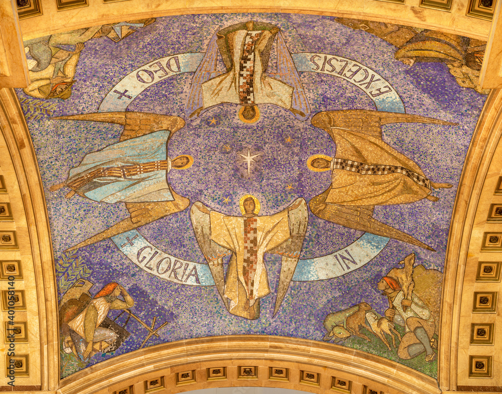 BARCELONA, SPAIN - MARCH 3, 2020: The modern mosaic of angels and the shepherds of Bethlehem on the cieling of presbytery in the chruch Iglesia de Belen by Santiago Padró (1960).