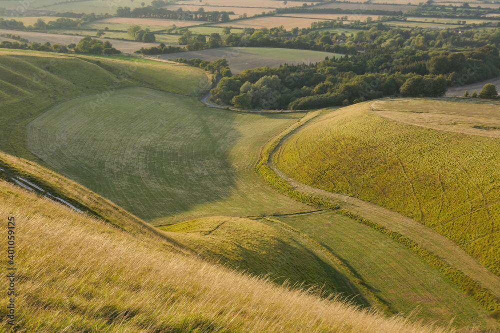 Curved grasslands seen from above at sunset from White Horse Hill Uffington 
