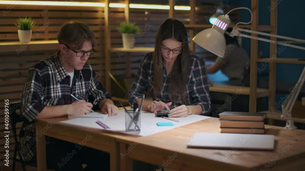 Creative Business Team, Business Project, Hipster Businessmen, Remote Work, Freelance Working. Young creative team working on a drawing while sitting at the table Creative Business Team, Business Project, Hipster Businessmen, Remote Work, Freelance Working. Young creative team working on a drawing while sitting at the table