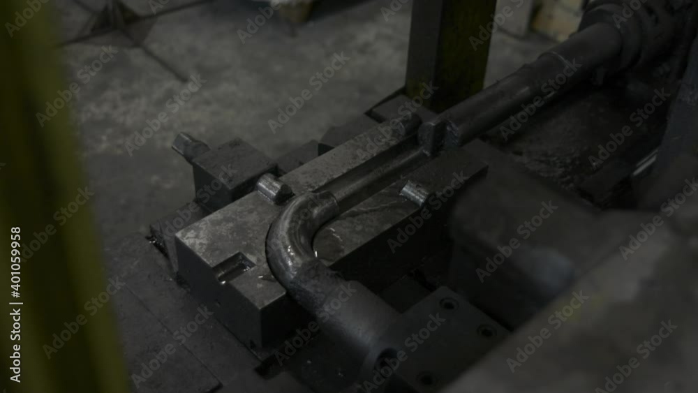 Close-up of metal-rolling machines for production metal steel pipes in factory. Seamless technology for production of profile pipe. Close-up of metal-rolling machines for production metal steel pipes in factory. Seamless technology for production of profile pipe.