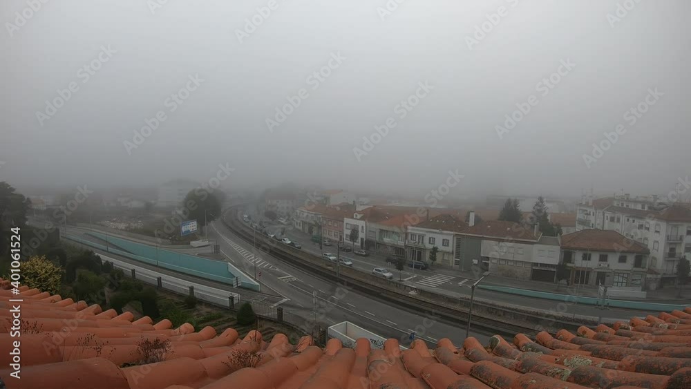 Viana do Castelo timelapse from a rooftop fog foggy day mist blur cloudy grey weather railroad traffic cars intersection av 25 de abril