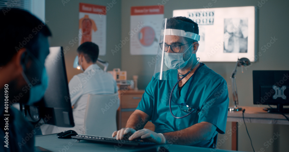Male patient in mask speaking with doctor Male patient in mask speaking with doctor