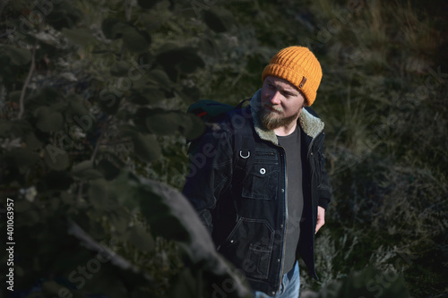 Portrait of a young lamber hiking man in forrest in automn and looking away. Concept of people traveling in nature.