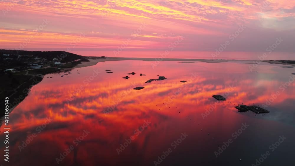 Drone aerial of a beautiful pink sunset over Lagoa de Albufeira, Portugal. Shot on a completely still mirrorlike lagoon. Drone aerial of a beautiful pink sunset over Lagoa de Albufeira, Portugal. Shot on a completely still mirrorlike lagoon.