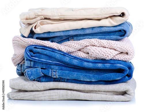 Stack folded jeans sweaters on white background isolation