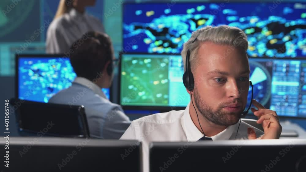 Workplace of the air traffic controllers in the control tower. Diverse team of aircraft control officers works using radar, computer navigation and digital maps. Aviation concept.