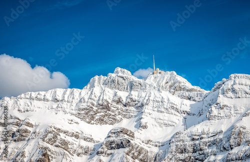 Hotel on snowy mountain top with blue sky