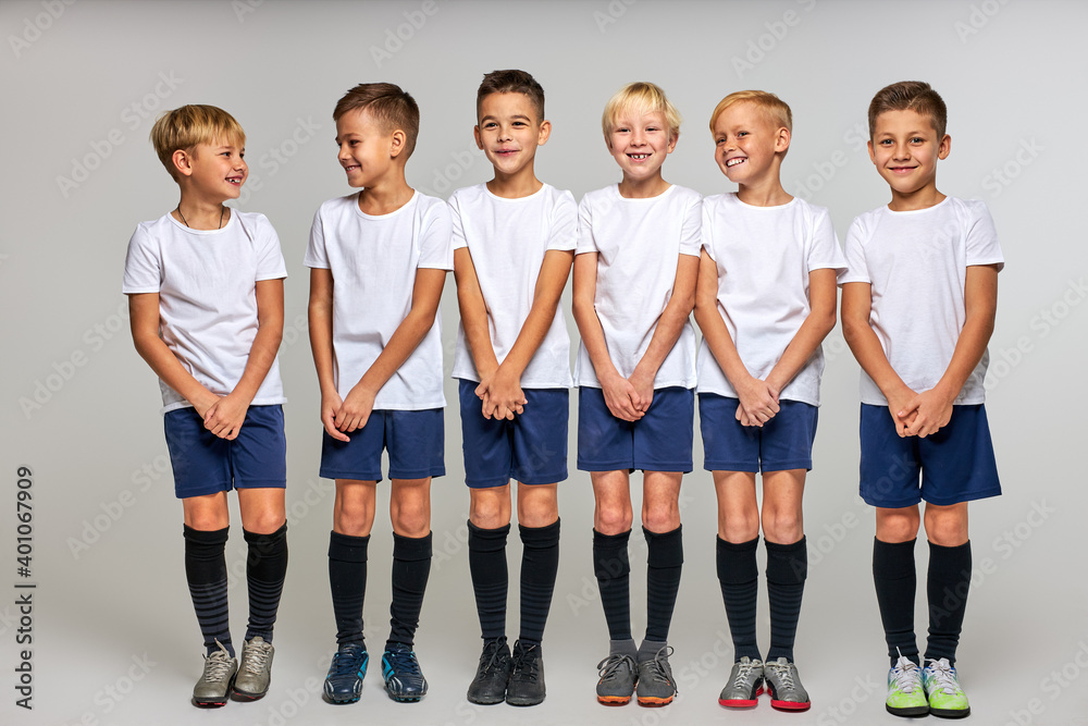 Obraz premium team of soccer players ready to take the ball, stood in a row, closing lower part of body, isolated portrait