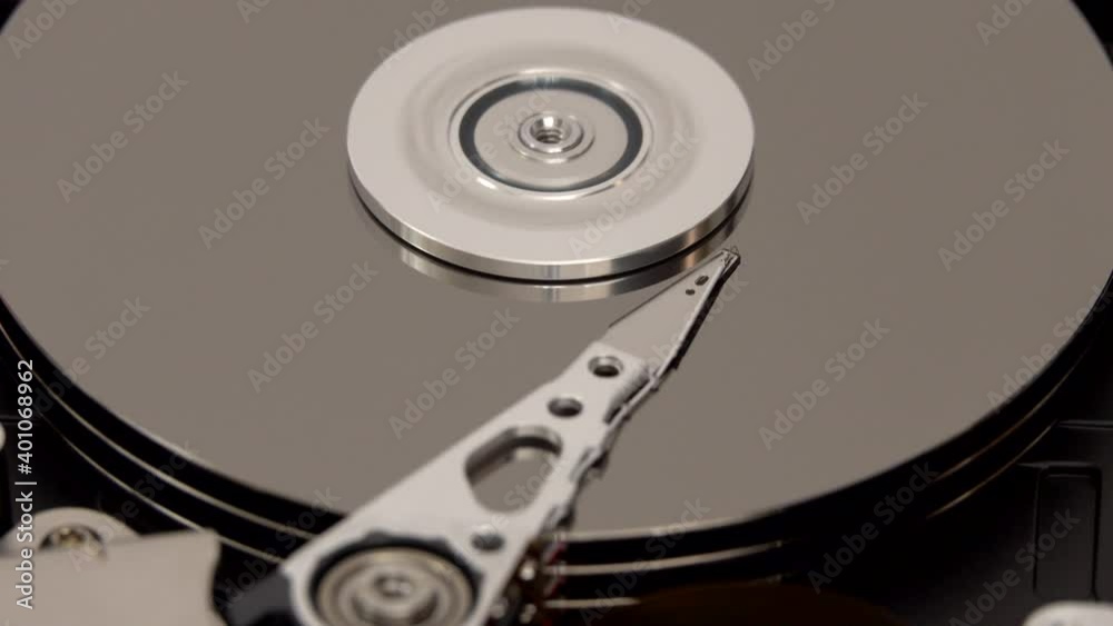 The read/write head of the actuator arm, disk platter, and spindle of a ...