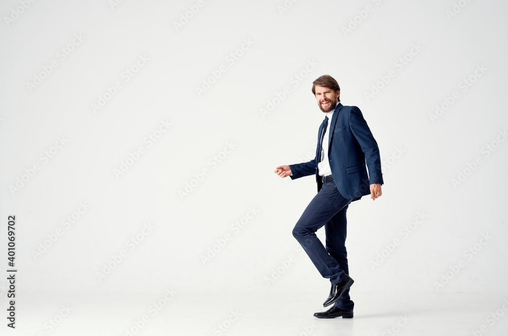 business man in a suit goes to the side on a light background side view Copy Space
