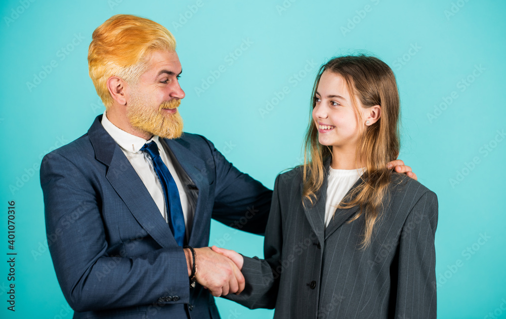 Welcome on board. business meeting. modern office life. businessman dyed blond hair. small girl in oversized suit jacket. future career. family business. partnership. teamwork of daughter and dad Welcome on board. business meeting. modern office life. businessman dyed blond hair. small girl in oversized suit jacket. future career. family business. partnership. teamwork of daughter and dad