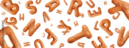 Chaotic flying letters made of real cookies, isolated on white background, closeup