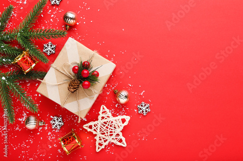Gift box with ornaments on red background