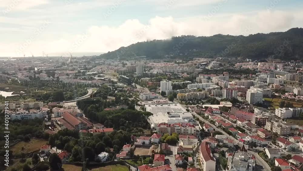 view of the city Viana do Castelo Portugal look from above drone shot aerial birds eye sunny day red rooftops streets cars driving flying upwards view of the city Viana do Castelo Portugal look from above drone shot aerial birds eye sunny day red rooftops streets cars driving flying upwards