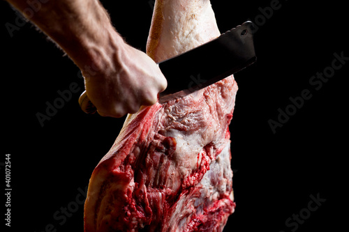 Cuting big piece of pork. Butcher hand close up.